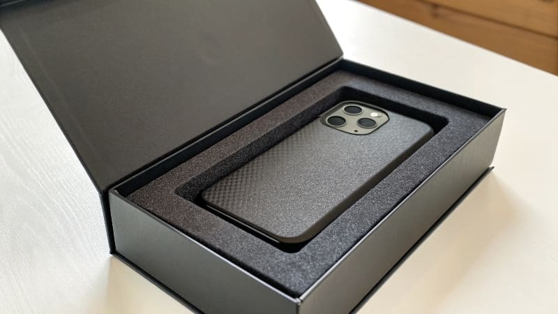 Customer Sharing an Unboxing Experience An excited person recording an unboxing video of a beautifully designed custom box for social media.