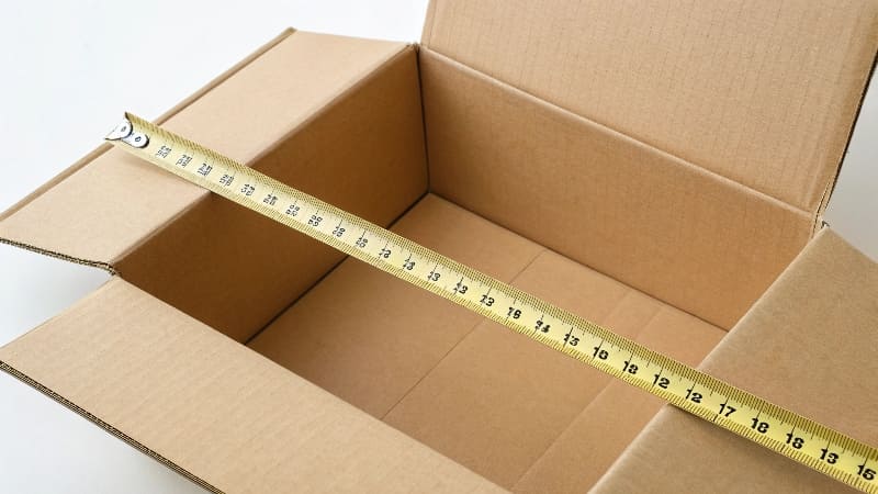 A tape measure showing the inside dimensions of a box alt with keywords