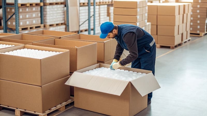 A packing station showing an easily foldable custom [mailer box](https://wansapackaging.com/do-you-have-any-idea-of-custom-product-boxes/)<sup id=