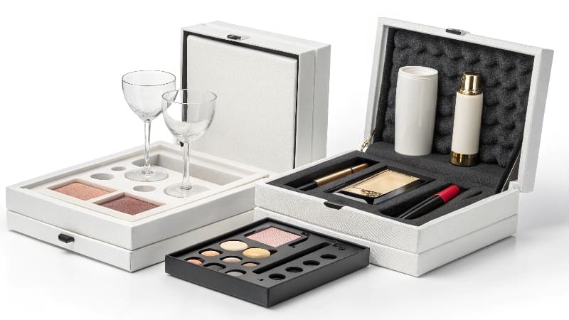A luxurious cosmetic set nestled in a silk-lined custom insert inside a rigid box.