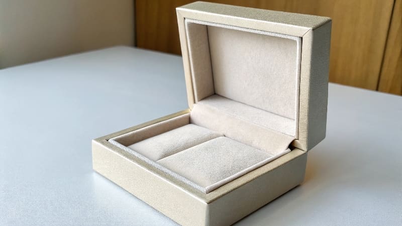 Best Packaging for Jewelry A close-up of a stunning ring resting in a plush, velvet-lined custom jewelry box.